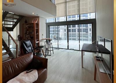 Spacious living room with high ceiling and modern decor