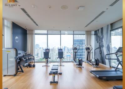 Modern home gym with large windows overlooking the city