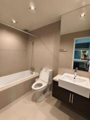 Modern spacious bathroom with bathtub, shower, toilet, and sink