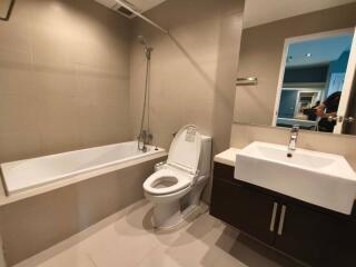 Modern bathroom with bathtub, toilet, and sink