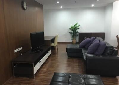 Spacious and modern living room with comfortable seating and television setup