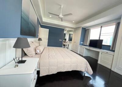 Elegant master bedroom with desk area and modern design