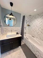 Modern bathroom with elegant design features, including a unique bathtub and stylish sink