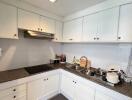 Modern kitchen with white cabinetry and granite countertop