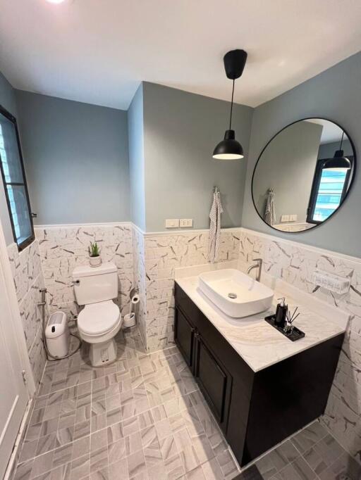 Elegantly designed modern bathroom with geometric floor tiles and stylish fixtures
