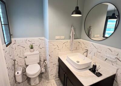 Elegantly designed modern bathroom with geometric floor tiles and stylish fixtures