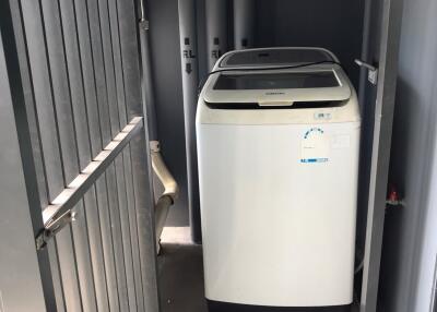 Compact laundry area with Samsung washing machine