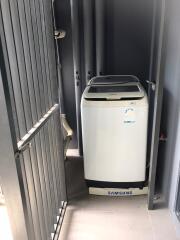 Compact laundry area with Samsung washing machine