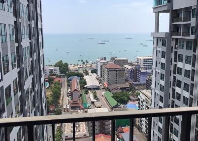 High-rise balcony view overlooking the sea with surrounding cityscape