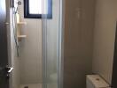 Compact modern bathroom with shower enclosure and toilet