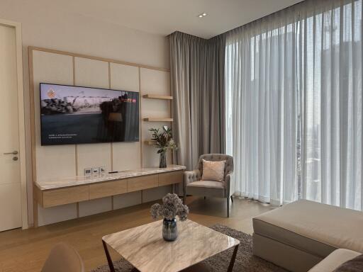 Elegant living room with modern furnishings and ample natural light