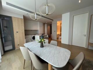 Spacious modern living area with dining set and open kitchen