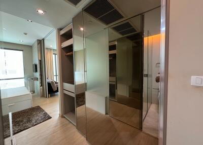 Modern bedroom with mirrored wardrobe and wooden flooring