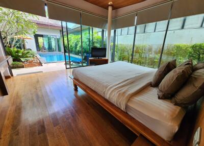 Spacious bedroom with large bed and pool view