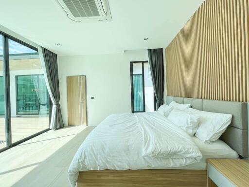 Modern bedroom with large windows and minimalistic design