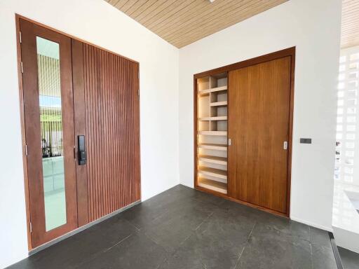 Modern entryway with wooden doors and slate flooring