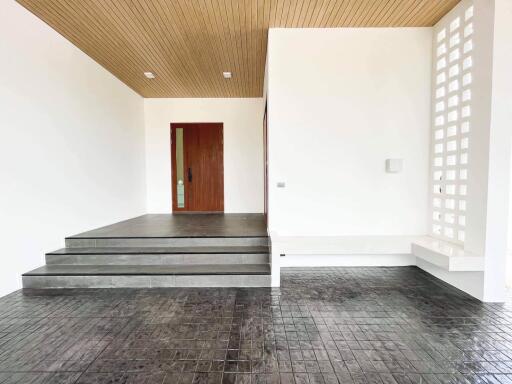 Spacious living room with wooden ceiling and tiled flooring