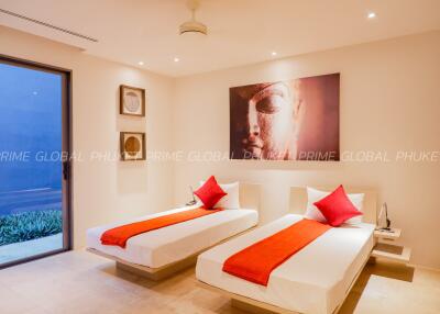 Modern bedroom with twin beds and elegant decor at Prime Global Phuket