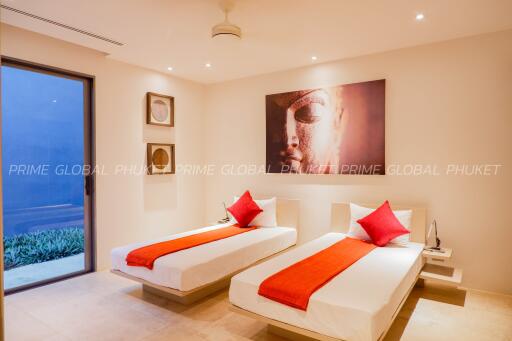 Modern bedroom with twin beds and elegant decor at Prime Global Phuket
