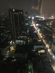 Night view of cityscape showing illuminated roads and high-rise buildings
