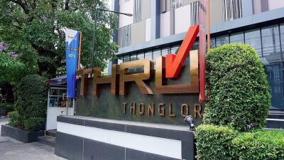 Exterior view of the Thonglor building with prominent signage