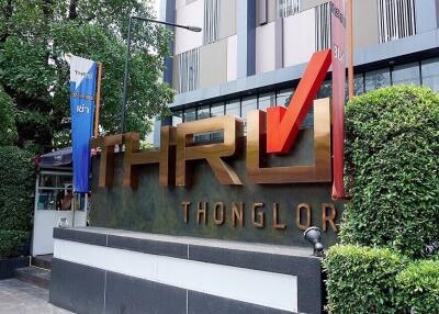 Exterior view of the Thonglor building with prominent signage