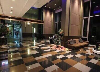 Elegant lobby area with checkerboard floor and modern furnishings