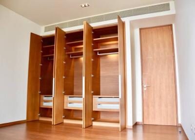 Spacious bedroom with large built-in wooden wardrobe