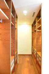 Spacious walk-in closet with wooden shelves and ample storage