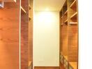 Spacious walk-in closet with wooden shelves and ample storage