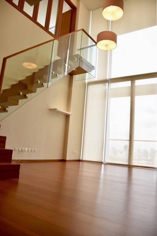 Modern living room with high ceiling and large windows