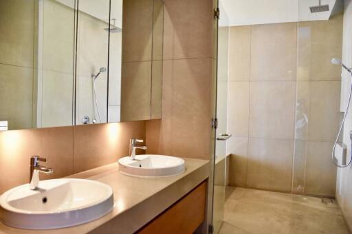 Modern bathroom with double sinks and glass shower