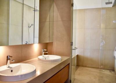 Modern bathroom with double sinks and glass shower