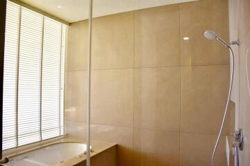 Spacious bathroom with modern shower and beige tiles