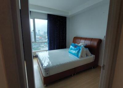 Well-lit bedroom with city view