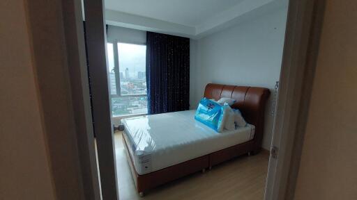 Well-lit bedroom with city view