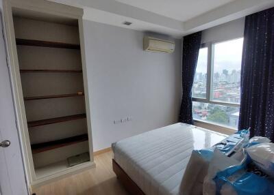 Spacious bedroom with open city view and built-in wardrobe