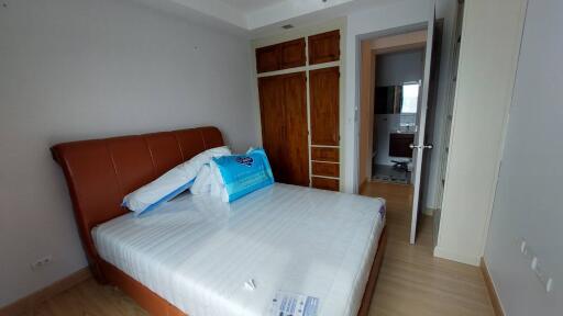 Spacious bedroom with large bed and wooden wardrobe