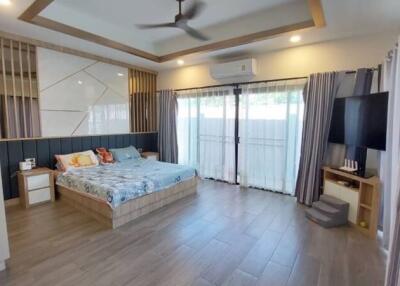 Spacious and modern bedroom with stylish design and large windows