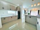 Spacious modern kitchen with ample cabinetry and elegant lighting