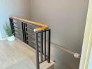 Modern staircase with wooden handrail and metal balusters