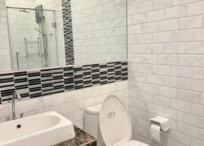 Modern bathroom interior with white tiles and marble sink