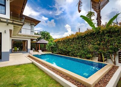 Luxurious backyard with swimming pool and modern home exterior