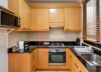 Modern kitchen with wooden cabinetry and stainless steel appliances