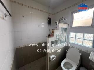 Bright and clean tiled bathroom with modern amenities