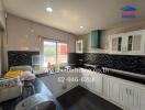 Spacious kitchen with modern appliances and stylish black tiles
