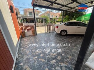Spacious carport area with well-maintained tile flooring and cover, suitable for parking and outdoor utilities