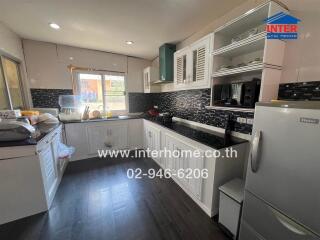 Spacious modern kitchen with sleek appliances and ample cabinetry