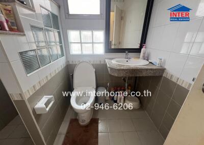 Modern bathroom with natural light and ample storage space