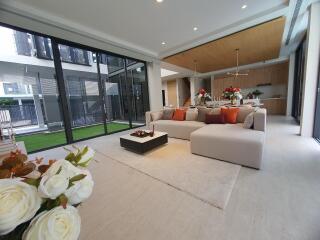 Spacious and modern living room with large windows and stylish furnishings